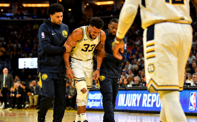 NBA球星伤病报道图片 - 球员在场上受伤被搀扶离场